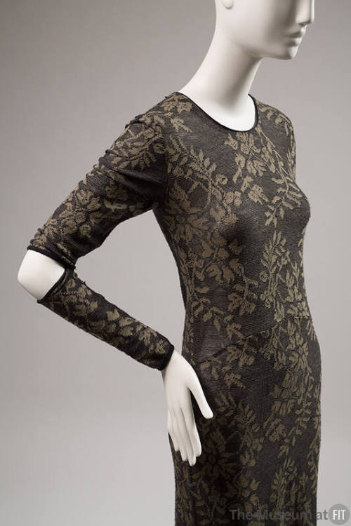 Black and olive green long sleeve dress with slit at elbows and vine and flower pattern