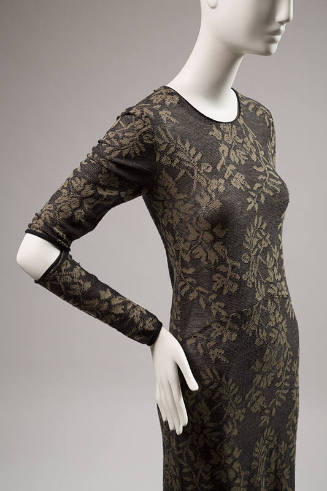 Black and olive green long sleeve dress with slit at elbows and vine and flower pattern