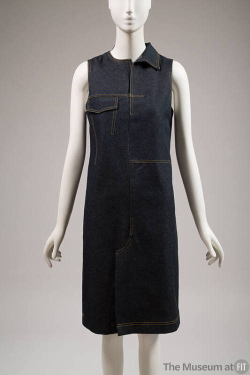 Dark blue denim sleeveless knee length dress with yellow topstitching, single right side collar…