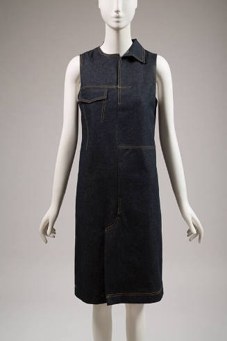 Dark blue denim sleeveless knee length dress with yellow topstitching, single right side collar…