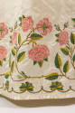 Detail of off-white silk hem with embroidered rose vines and leaf border 