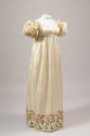 Off-white silk floor length dress with empire waist, short puff sleeves, hem with embroidered r…