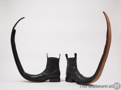 Black leather boots, stretch sides, black pull loops, long upturned curled pointed toes