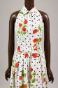 Detail of sleeveless top with orange, pink with green stem rose print and black polka dot patte…