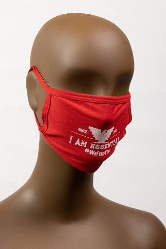 Red face mask with white text: I Am Essential and #wefeedyou