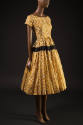 Yellow and brown peanut print short sleeve scoop neck dress, gathered skirt with black band and…