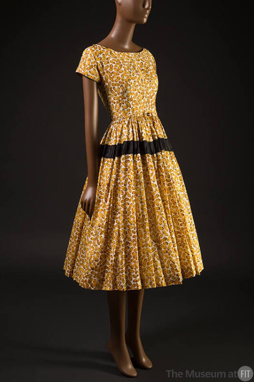 Yellow and brown peanut print short sleeve scoop neck dress, gathered skirt with black band and…