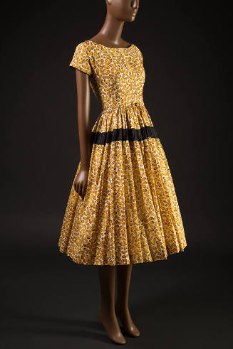 Yellow and brown peanut print short sleeve scoop neck dress, gathered skirt with black band and…