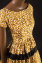 Yellow and brown peanut print short sleeve scoop neck dress, gathered skirt with black band and…