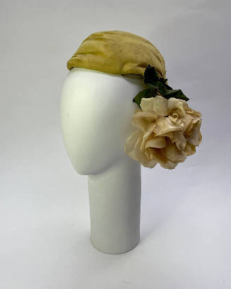 Yellow turban with oversize white silk rose on right side