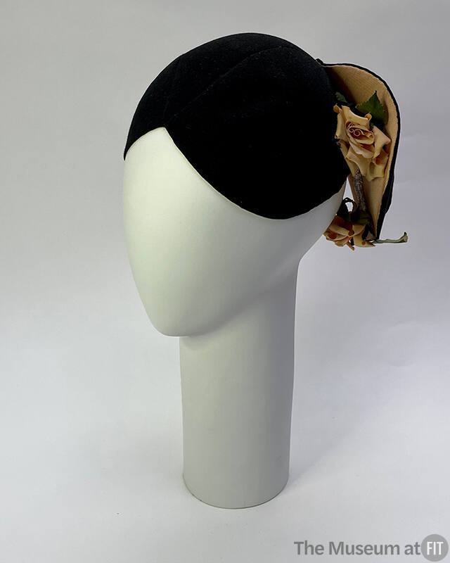 Black helmet hat cut to form projecting flanges in back