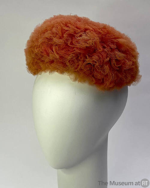 Domed hat formed from layers of scrunched pink net