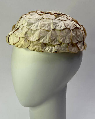 round hat made of overlapping white fabric petals