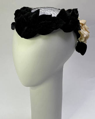 Small hat of black velvet leaves and white flowers