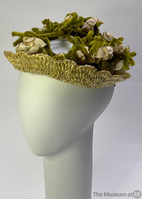 Light green straw hat iwth off-white artificial flowers