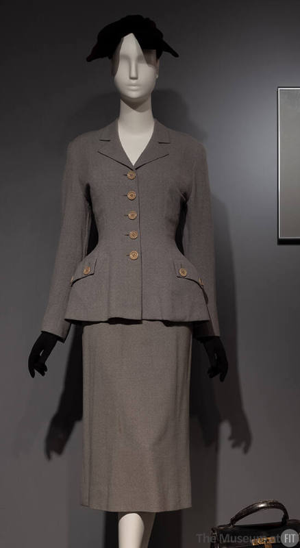 Grey flannel suit, jacket with accentuated waist silhouette and straight skirt