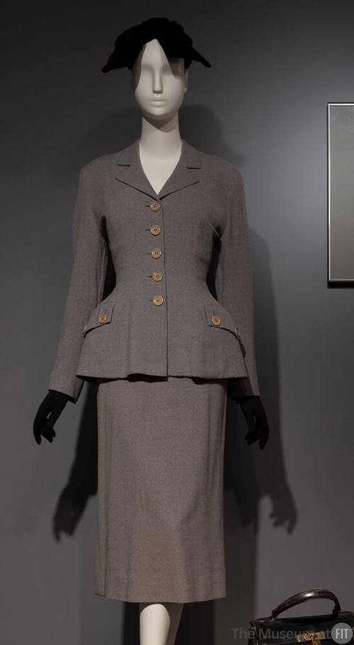 Grey flannel suit, jacket with accentuated waist silhouette and straight skirt