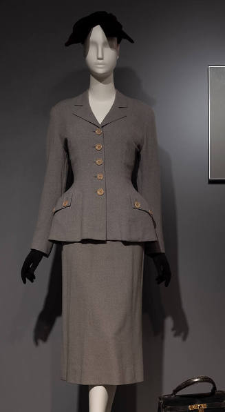 Grey flannel suit, jacket with accentuated waist silhouette and straight skirt