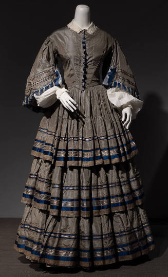 Grey silk taffeta floor length dress with bell sleeves and full pleated skirt with three ruffle…