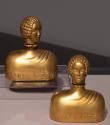Metallic gold glass perfume bottle in the shape of a female bust