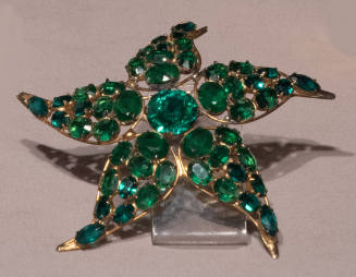 Starfish shaped pin with green stones on gold plated sterling silver setting

