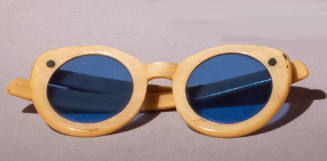 Yellow rounded cat eye sunglasses with bright blue lens