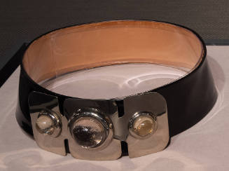 Wide black leather belt with large silvertone metal front plate with three clear stones