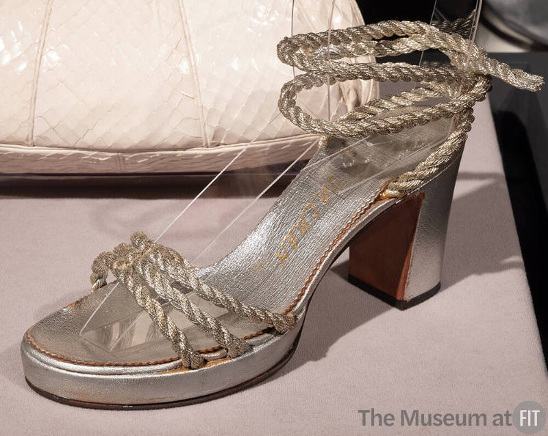 Silver sandal with high block heel, three pieces of silver rope across instep and rope ankle ti…