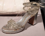 Silver sandal with high block heel, three pieces of silver rope across instep and rope ankle ti…