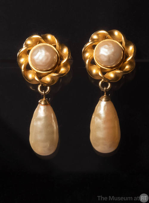 Clip on earrings: twisted matte gold button design with faux pearl at center and large teardrop…