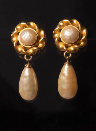 Clip on earrings: twisted matte gold button design with faux pearl at center and large teardrop…