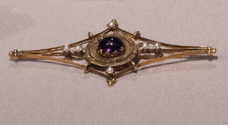 Oblong diamond shaped gold brooch with center oval amethyst in circular setting with small pear…