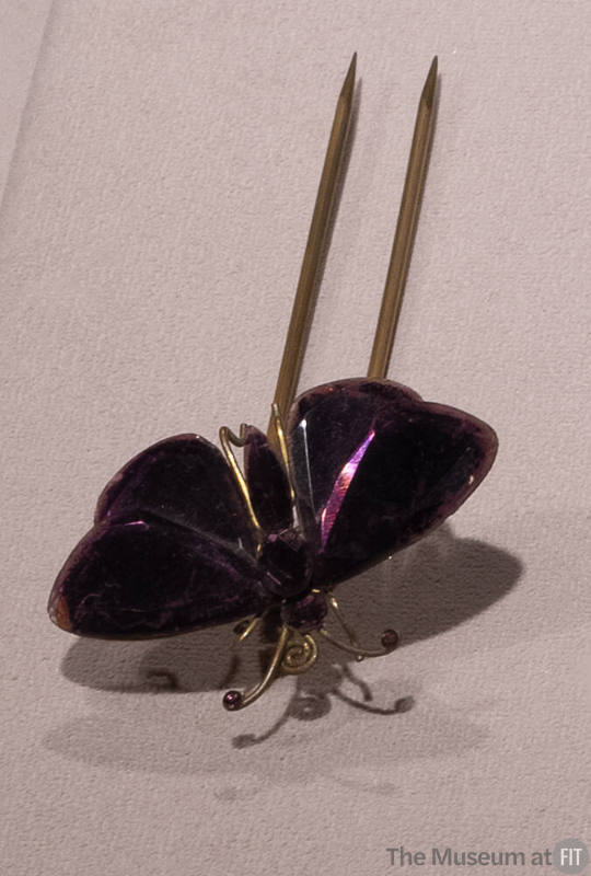 Purple glass butterfly hat pin with gold metal accents and double prong