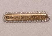 Gold bar pin with floral design edged with seed pearls