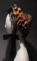 Tan velvet bonnet with black lace and pink velvet flowers and leaves throughout