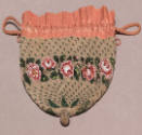 Beige beaded reticule with pink drawstring top and horizontal band of pink and green roses in c…