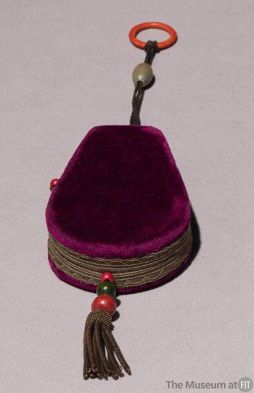Purple velvet hard case bag with orange finger ring, gold braided trim and beads