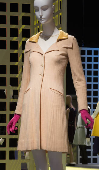 Cream wool coat with yellow collar and three button closure dressed with bright pink gloves