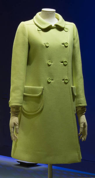 Yellow green double breasted short coat, two rounded flap pockets and round neckline