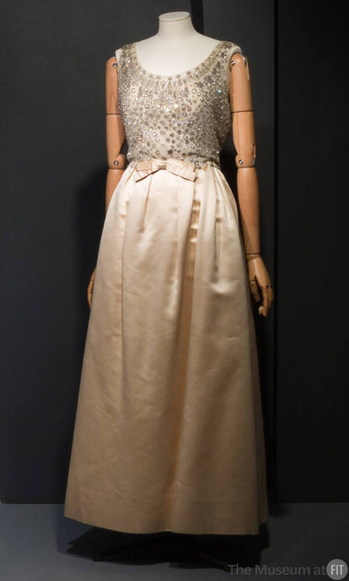 Off white sleevless gown with white net bodice embellished with silver thread embroidered cricl…