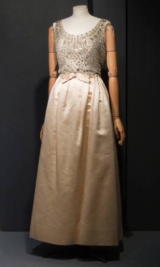 Off white sleevless gown with white net bodice embellished with silver thread embroidered cricl…
