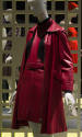 Red leather coat over matching belted halter neck jumper dress over black turtleneck sweater 
