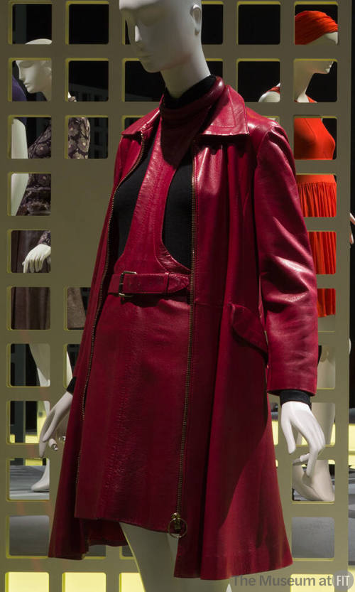 Red leather coat over matching belted halter neck jumper dress over black turtleneck sweater 