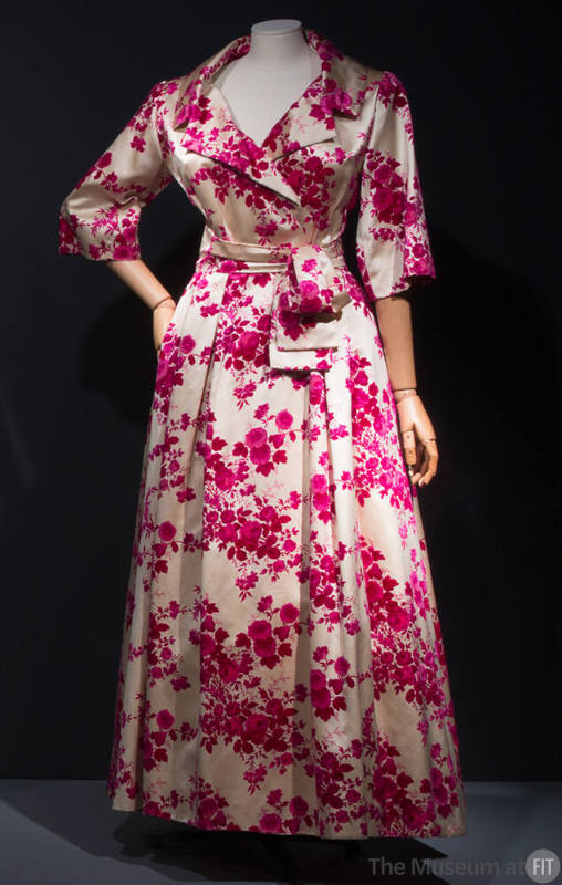 Off-white coat dress with allover pink floral design, wide neckline with notched lapels, matchi…
