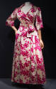 Off-white coat dress with allover pink floral design, wide neckline with notched lapels, matchi…
