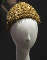 Metallic gold hat made of wrapped bullion cord and embellished overall with stones, beads and c…