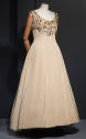 Beige silk sleeveless dress with gold floral embroidery at round neckline and bust, floor lengt…