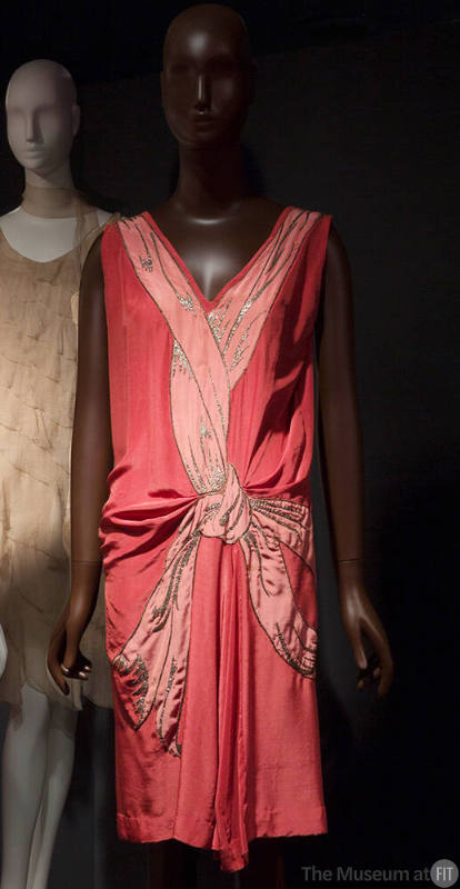 Rose pink sleeveless knee length dress with light pink and silver applique of ribbon running al…