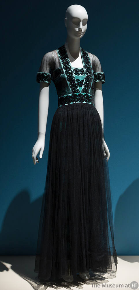 Short sleeve evening gown of black net and blue silk satin bodice with black circular pattern a…