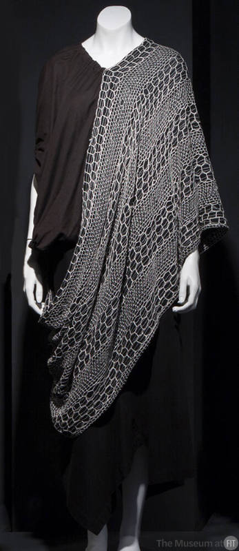 Black short sleeve top with white net poncho style overlay